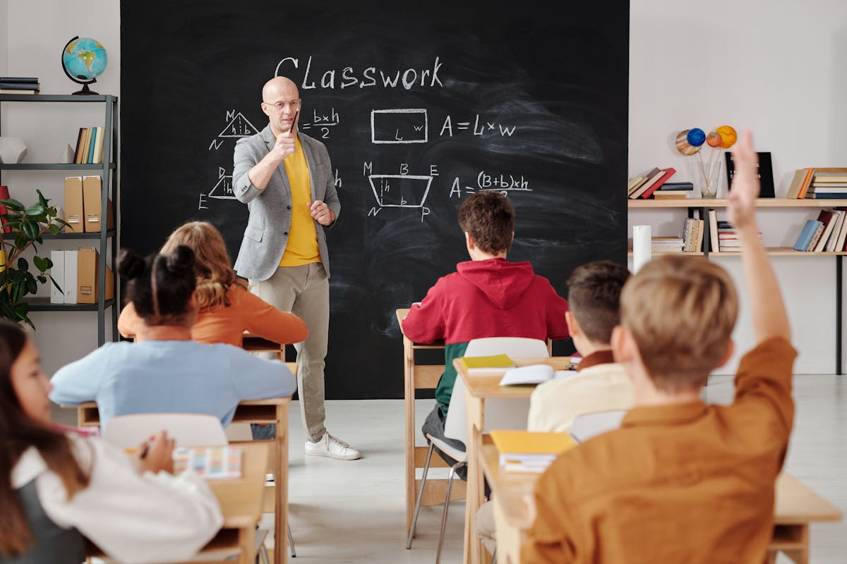 Educator reviewing student assessments and marking academic performance records