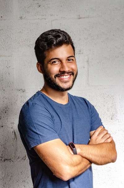 Confident professional man with arms crossed, smiling in business attire